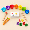Count and Clip game with seven colourful sorting bowls, beads, stacked number cards, tongs, spoon, wooden sticks and number pieces on warm beige.