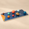 Solar System Planet Puzzle Board with eight raised planet pieces on a warm beige studio surface.