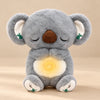 Sleepy Koala Breathing Buddy plush with a softly glowing belly.