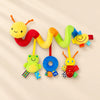 Colourful soft spiral toy with a smiling yellow head, a frog, a blue plush ring and a red bug hanging beneath.