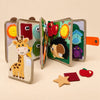 TibaToes BusyBuddy felt activity book opened to its animal and matching pages on a warm beige background.