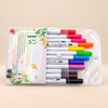 RainbowBrush Dual-Tip Marker Set. 12-Color Creative Brush Set. Clean product photograph on a warm beige studio surface.