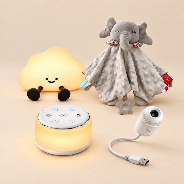 Dreamy Elephant Bedtime Routine Bundle with cloud light, grey elephant blanket, sound machine and white USB projector on a softly lit warm beige studio surface.