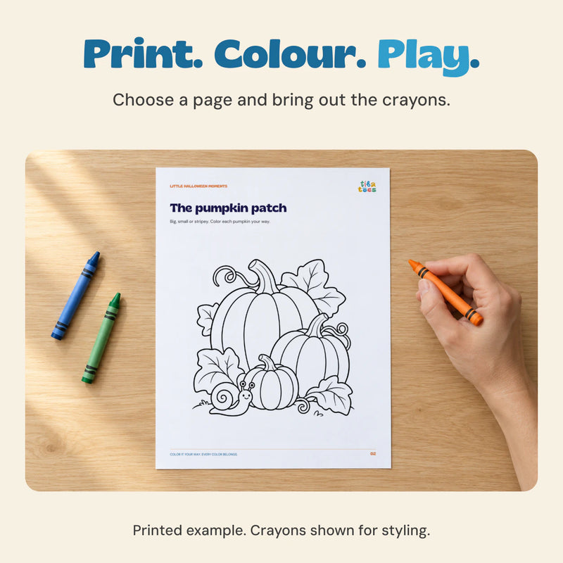 Adult hand holding an orange crayon beside the actual pumpkin patch colouring page printed on a loose sheet.