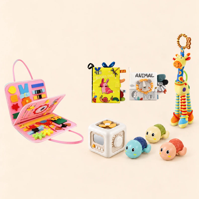 Mermaid Pink busy board with a busy cube, Garden Fun cloth book, Animal lion soft book, giraffe rattle and three turtle bath toys on a pale beige background.