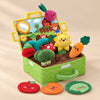 Open Sensory Garden plush activity box with its colourful vegetables and matching fabric pieces on a warm beige studio surface.