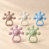 LittleGrip Silicone Teether Rattle on a warm beige studio background