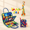 Dinosaur Blue Sensory Explorer Bundle with its busy board, dinosaur soft book, giraffe toy and hanging spiral toy on a warm beige background.