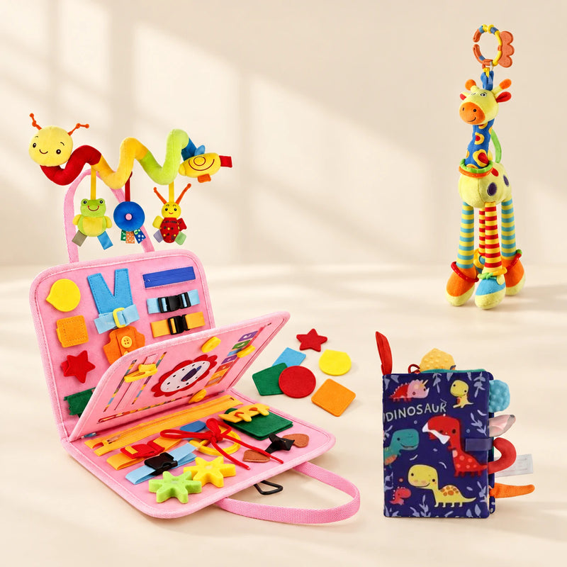 Mermaid Pink Sensory Explorer Bundle with its busy board, dinosaur soft book, giraffe toy and hanging spiral toy on a warm beige background.