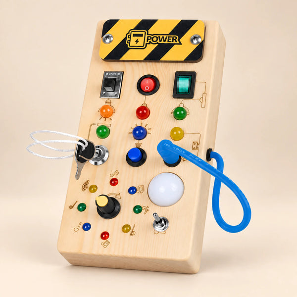Montessori wooden switch board on a smooth warm beige studio surface, with its original switches, lights, key and blue cord.