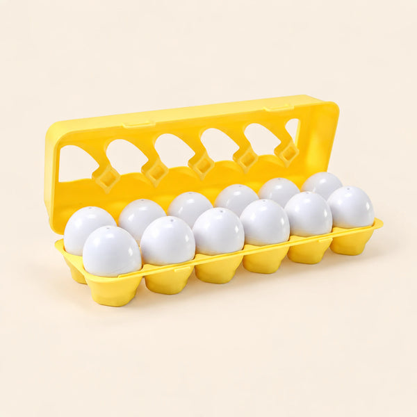 Twelve white shape-sorting eggs in their open yellow case on warm beige.