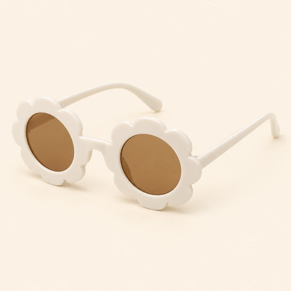 One pair of flower-shaped sunglasses with round brown lenses in the White colour on a warm beige background.