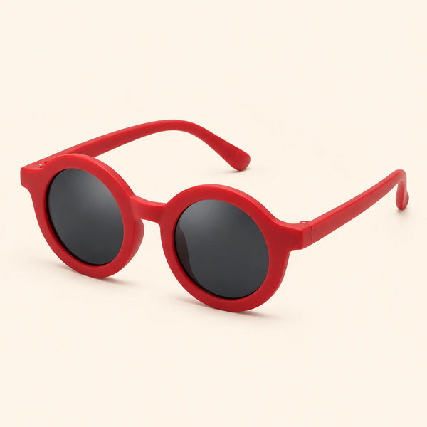 One pair of round sunglasses in the Cherry Red option on a warm beige background.