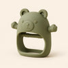 Green bear teether with raised face, rounded ears, side paws and open-centre grip on warm beige.