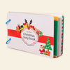 Photographed Christmas busy book with a red band, festive cover illustrations and blue binding rings, isolated on warm beige.