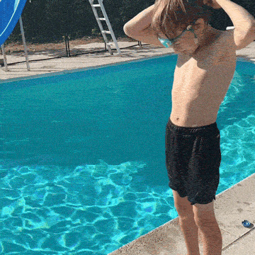 Child clipping on the goggles at the pool