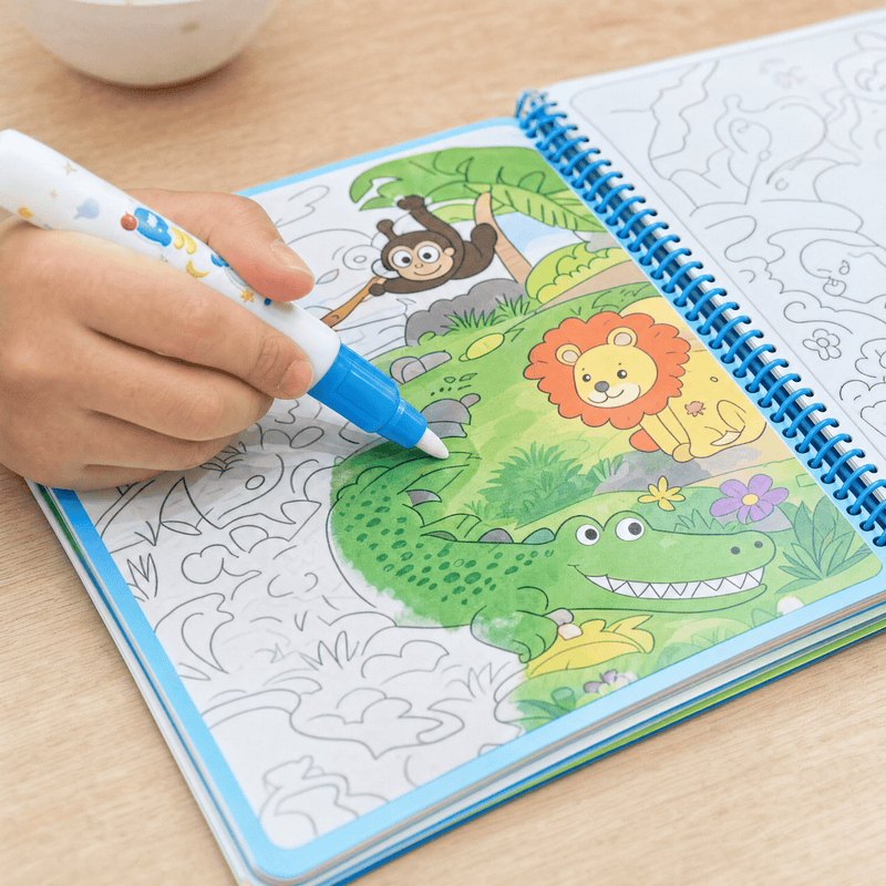 Toddler coloring calmly with a TibaToes MagicSplash water drawing book