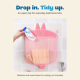 Existing source hand placing a bottle into the pink rabbit mesh organizer. Toiletries and towel are not included.