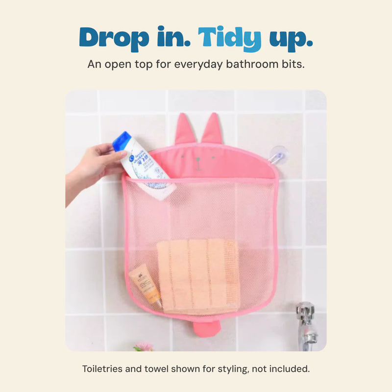 Existing source hand placing a bottle into the pink rabbit mesh organizer. Toiletries and towel are not included.
