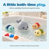 The grey whale sprays water beside three turtles in a white bath. Foam letters A, B and C rest on the bath edge.
