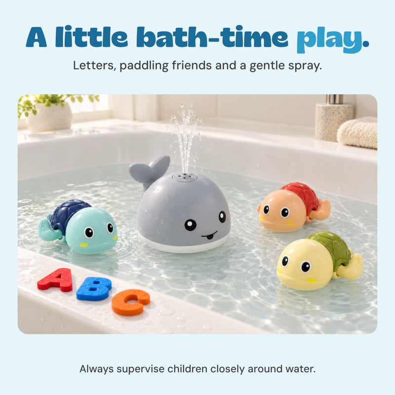 The grey whale sprays water beside three turtles in a white bath. Foam letters A, B and C rest on the bath edge.