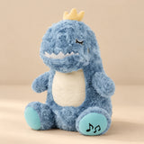 Blue Dino Breathing Buddy plush with a yellow crown, cream belly and turquoise footpads.