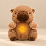 Cocoa Capybara Breathing Buddy plush with a softly glowing apple belly.