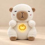 Cream Capybara Breathing Buddy plush with tan ears, muzzle and feet, and an apple belly light.