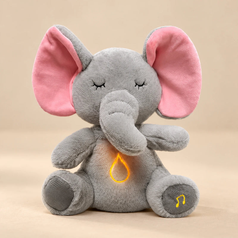 Sleepy Elephant Breathing Buddy plush with pink ears and a warm belly light.