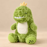 Green Dino Breathing Buddy plush with a yellow crown, cream belly and green footpads.