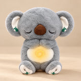 Sleepy Koala Breathing Buddy plush with a softly glowing belly.