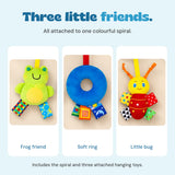Close views of BusyBuggy's three attached hanging toys: a green frog, a blue soft ring and a red bug.