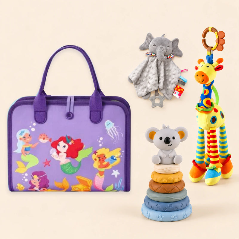 Mermaid Purple Plus busy board with a grey elephant snuggle blanket, blue-neck yellow giraffe rattle and six-ring koala stacking tower on a pale beige background.
