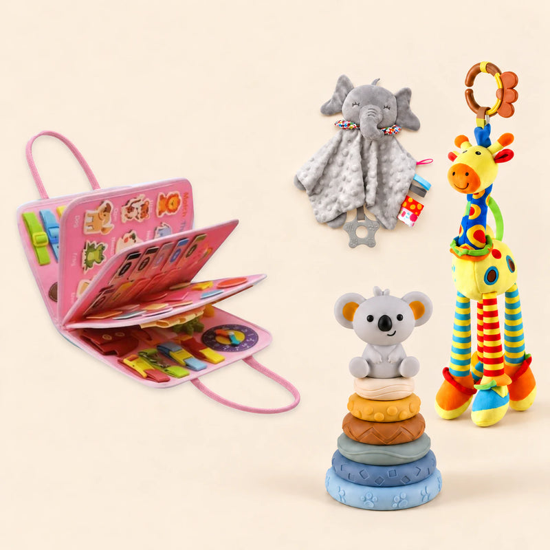 Mermaid Pink Plus busy board with a grey elephant snuggle blanket, blue-neck yellow giraffe rattle and six-ring koala stacking tower on a pale beige background.