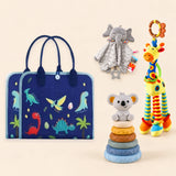 Dinosaur Blue Plus busy board with a grey elephant snuggle blanket, blue-neck yellow giraffe rattle and six-ring koala stacking tower on a pale beige background.