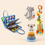 Vehicle Blue Plus busy board with a grey elephant snuggle blanket, blue-neck yellow giraffe rattle and six-ring koala stacking tower on a pale beige background.