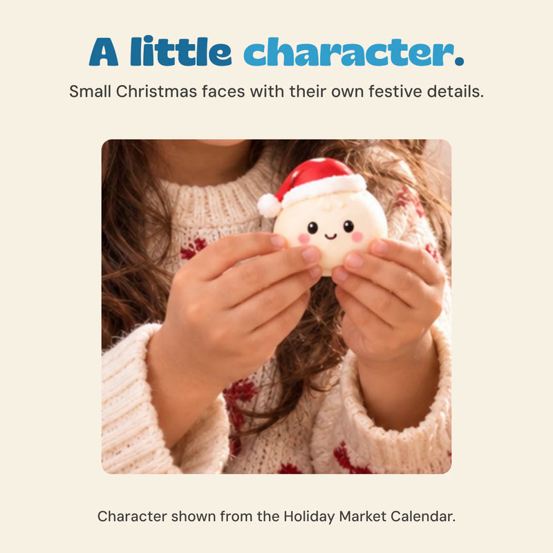 Original hands holding a white dumpling character with pink cheeks and a red Santa hat.