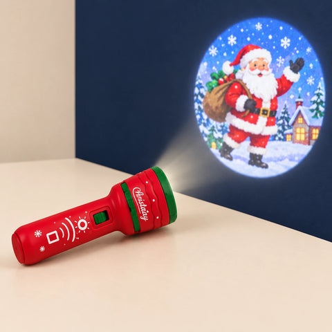 Christmas Red flashlight projector on a warm beige surface, with a Christmas scene projected onto the darker wall.