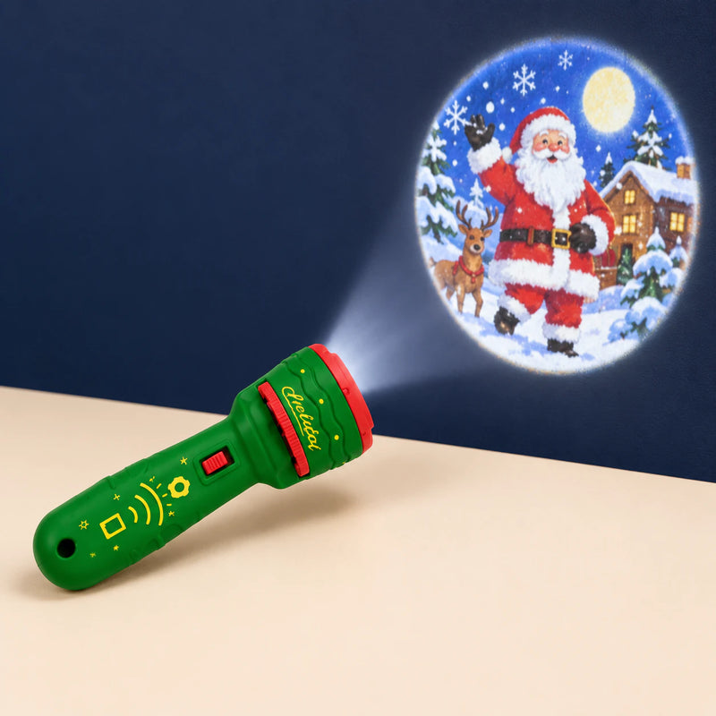 Holiday Green flashlight projector on a warm beige surface, with a Christmas scene projected onto the darker wall.