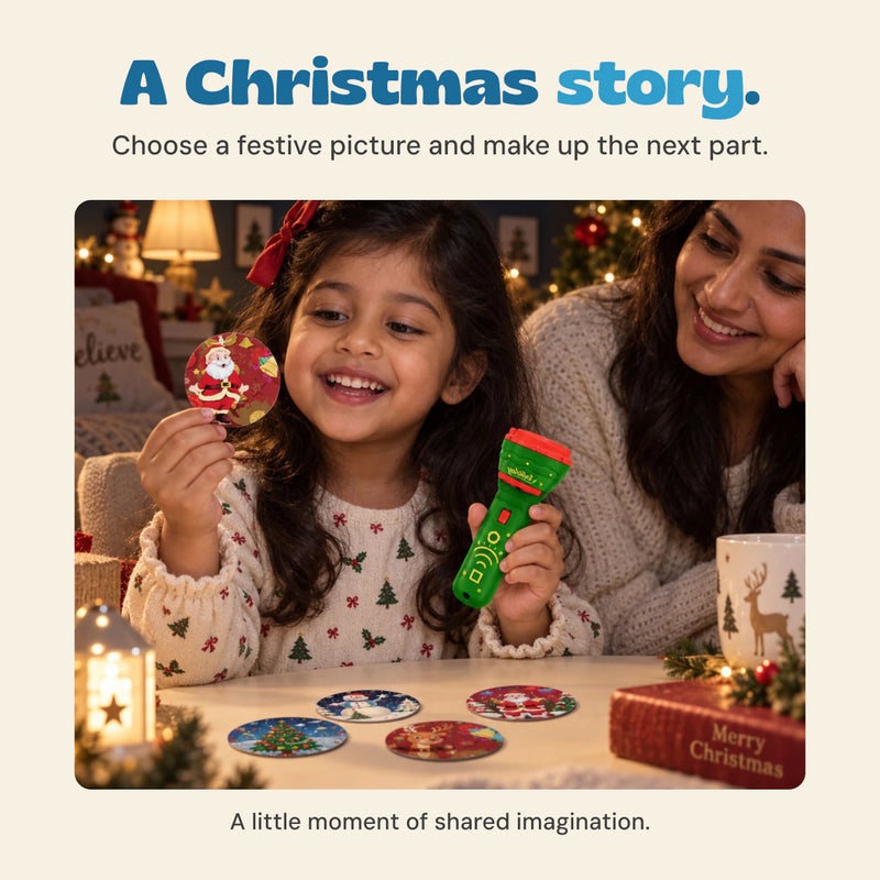 Original photograph of a child holding a Santa picture insert and the green projector beside an adult.