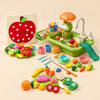 Little Kitchen Play Gift with Froggy Wash Station, Apple Deluxe felt food board and Little Chef Mix cutting toy foods arranged on a warm beige studio surface.