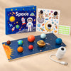 Big Space Adventure Gift with GalaxyGlow USB projector, eight-planet solar system board, blue Space quiet book and astronaut glow stickers on a warm beige studio surface.