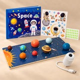 Big Space Adventure Gift with GalaxyGlow USB projector, eight-planet solar system board, blue Space quiet book and astronaut glow stickers on a warm beige studio surface.