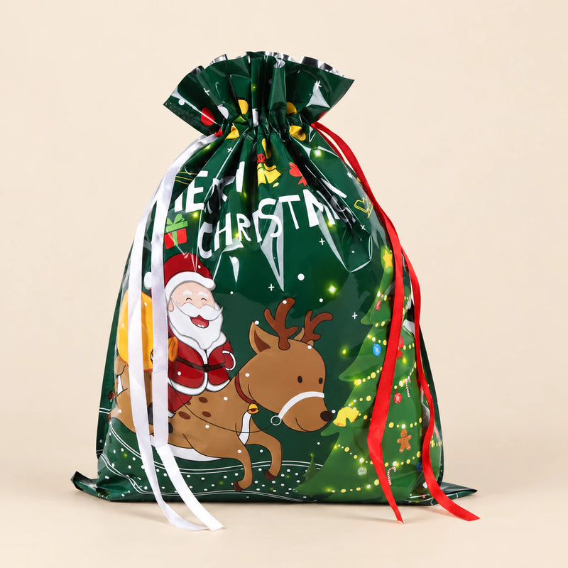 TibaToes Christmas Gift Bag, Large, Santa’s Little Helpers Green, ribbon closure on a warm beige studio background.