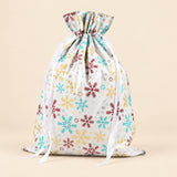 TibaToes Christmas Gift Bag, Large, Snowflake Confetti White, ribbon closure on a warm beige studio background.