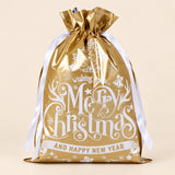TibaToes Christmas Gift Bag, Medium, Christmas Wishes Gold, ribbon closure on a warm beige studio background.