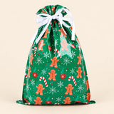 TibaToes Christmas Gift Bag, Medium, Gingerbread Giggles Green, ribbon closure on a warm beige studio background.