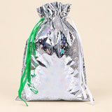 TibaToes Christmas Gift Bag, Medium, Snowflake Sparkle Silver, ribbon closure on a warm beige studio background.
