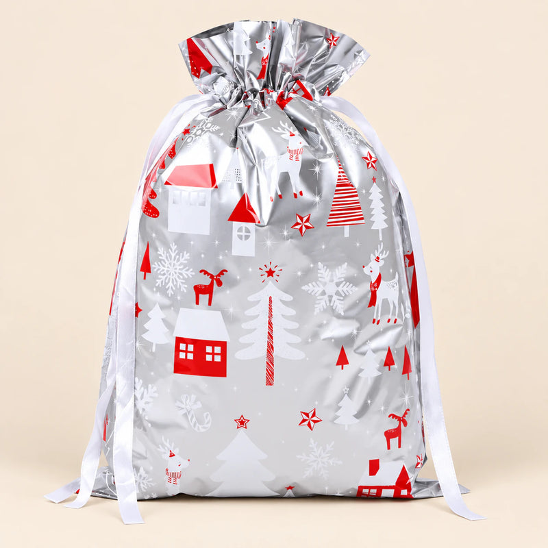 TibaToes Christmas Gift Bag, Medium, Snowy Village Silver, ribbon closure on a warm beige studio background.
