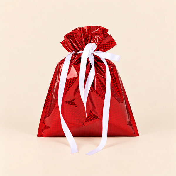 TibaToes Christmas Gift Bag, Small, Jolly Red, ribbon closure on a warm beige studio background.